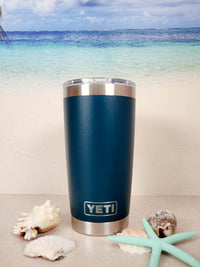 a blue yeti cup sitting on top of a table next to a starfish
