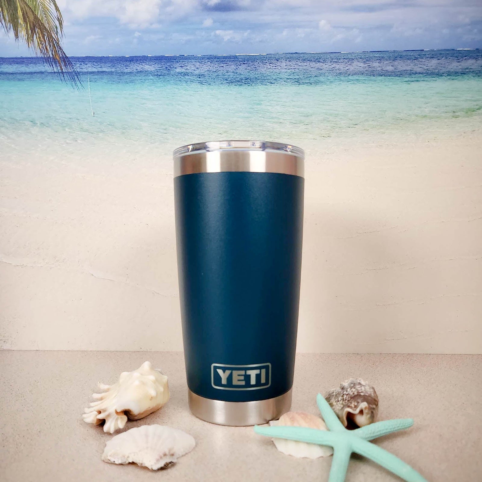 a blue yeti cup sitting on top of a table next to a starfish