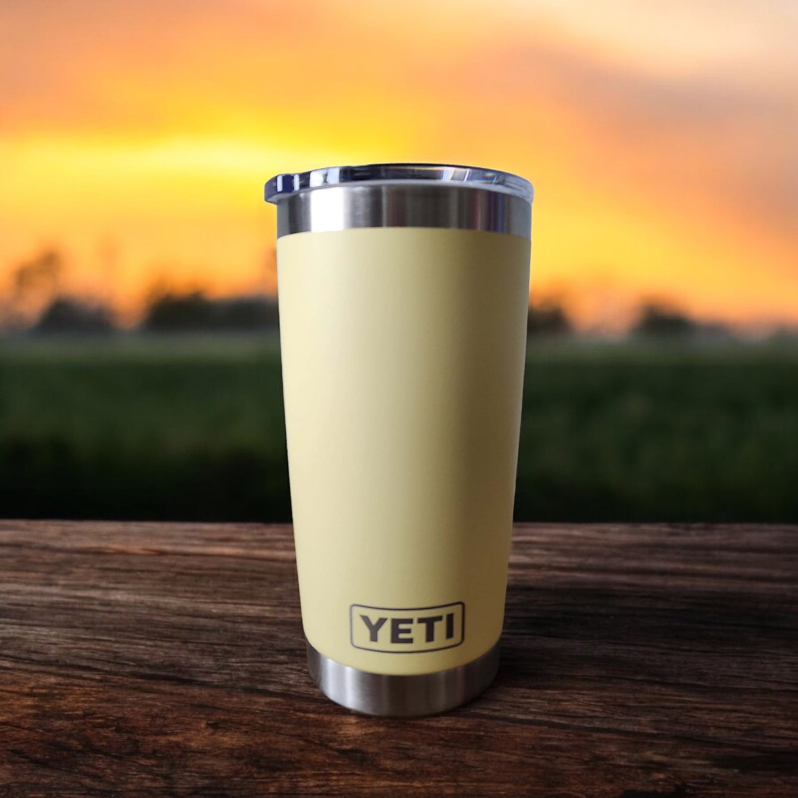 a yellow yeti cup sitting on top of a wooden table