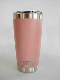 a pink yeti cup sitting on top of a white table