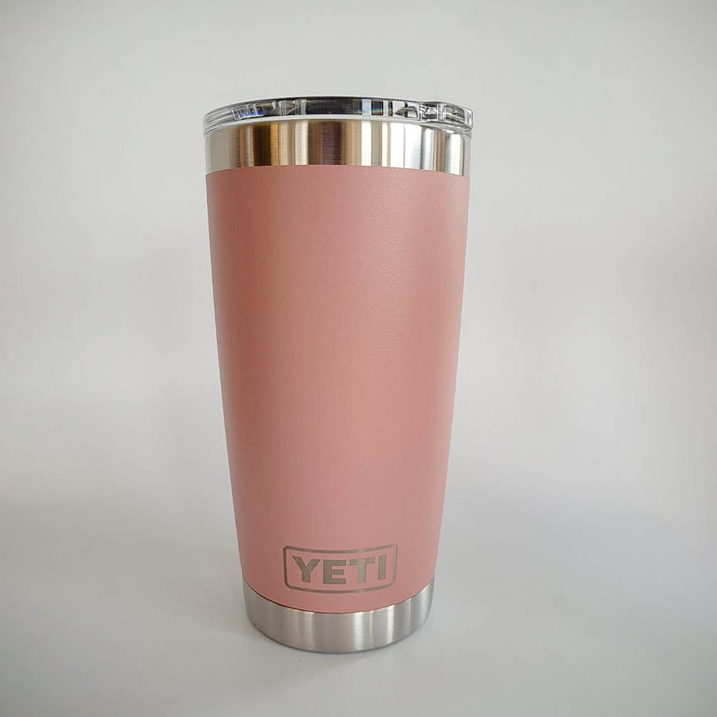 a pink yeti cup sitting on top of a white table