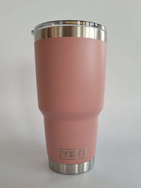 a pink yeti cup sitting on top of a table